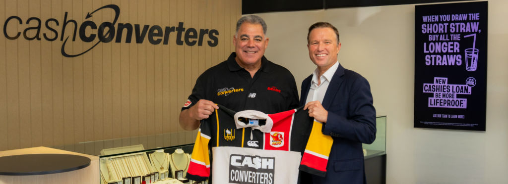 Image of Perth Bears Head Coach, Mal Meninga, with Sam Budiselik, CEO and Managing Director of Cash Converters, holding a branded rugby shirt
