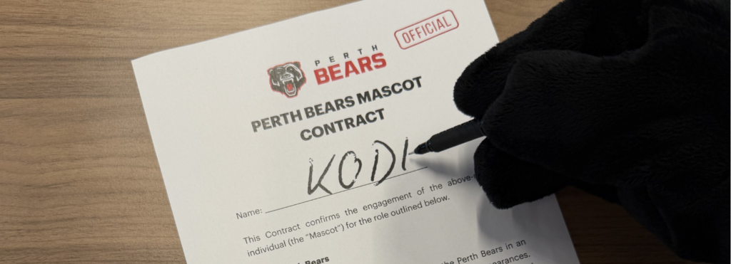 Image of a fake contract saying Perth Bear Mascot with a bear paw and pen scribing the name Kodi.