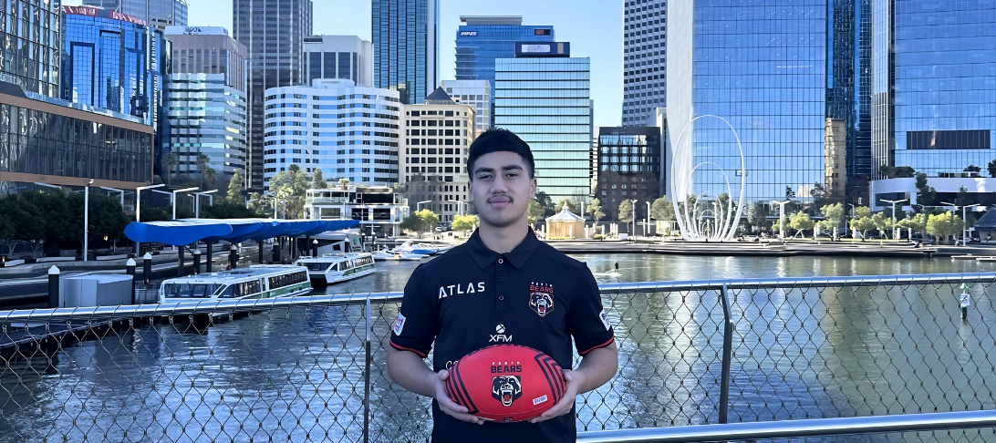 Image of Jasias Ah Kheen at Elizabeth Quay Perth, holding a rugby ball